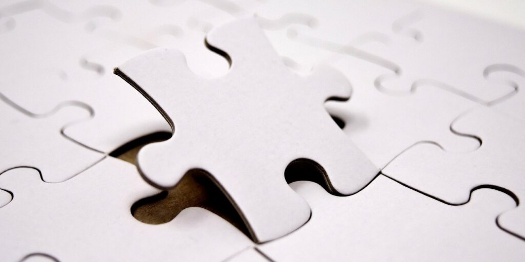 Placing a puzzle piece into a completed puzzle