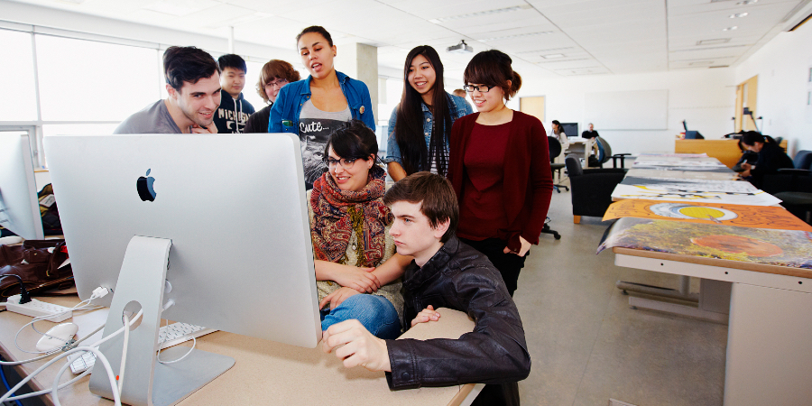 Student group working at a Mac computer