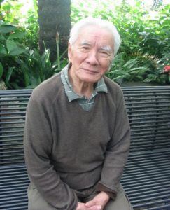 Photo of Jerome Ch'en sitting on a bench. Ch'en, a former Professor at York University, passed away on June 17, 2019