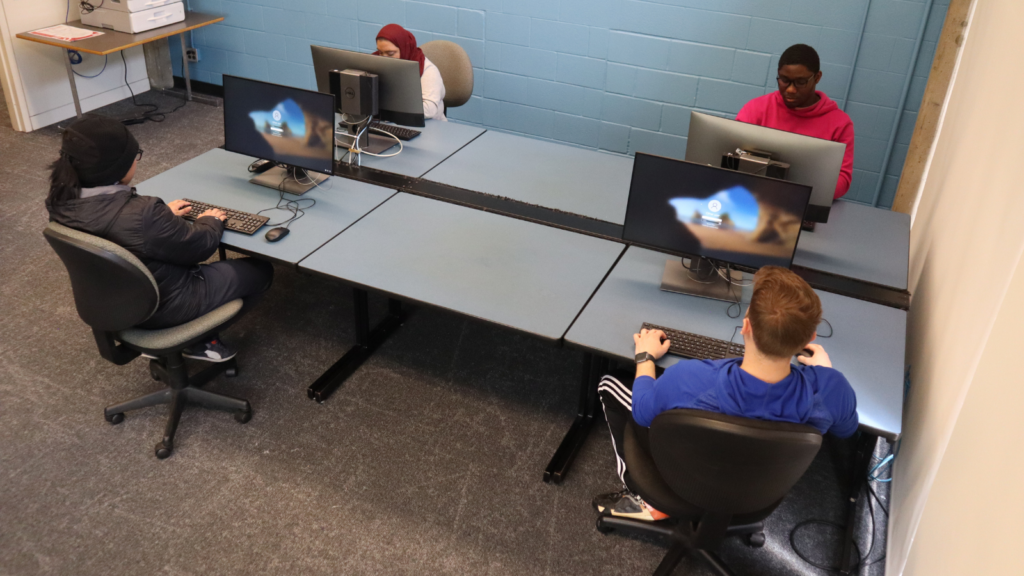 students working at computers in a foursome