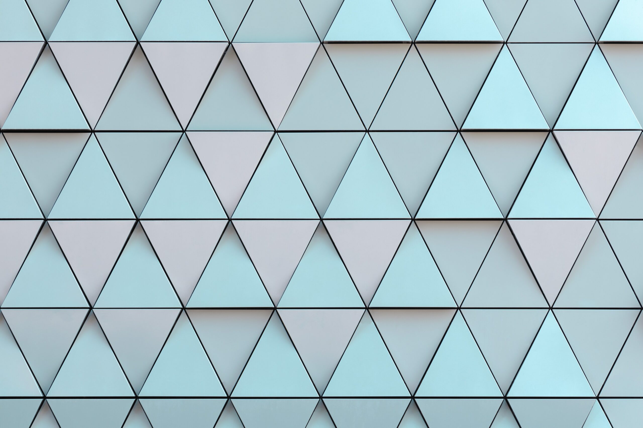 Textured background of alternating darker blue and lighter blue triangles.